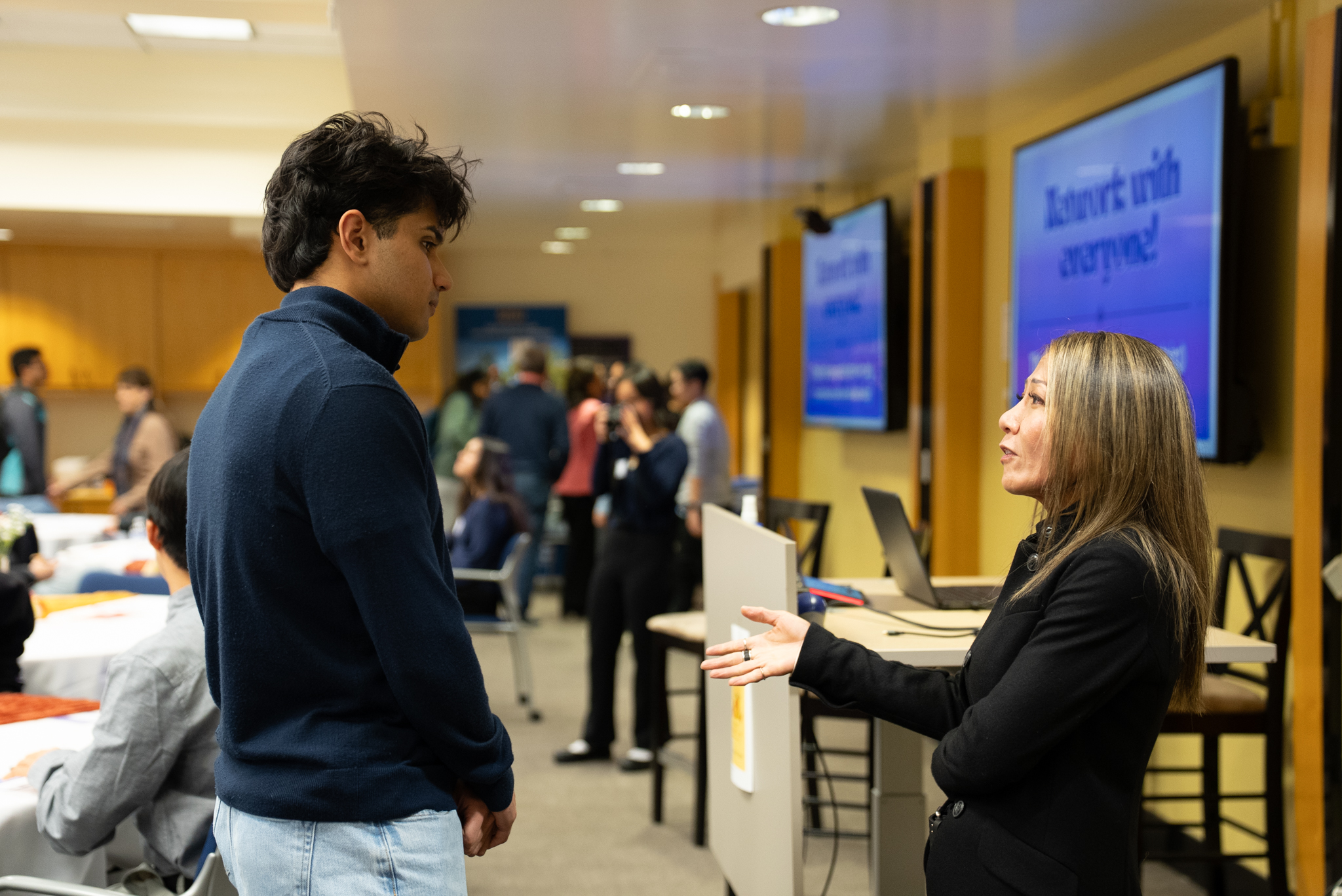 Students networking with Janice Le